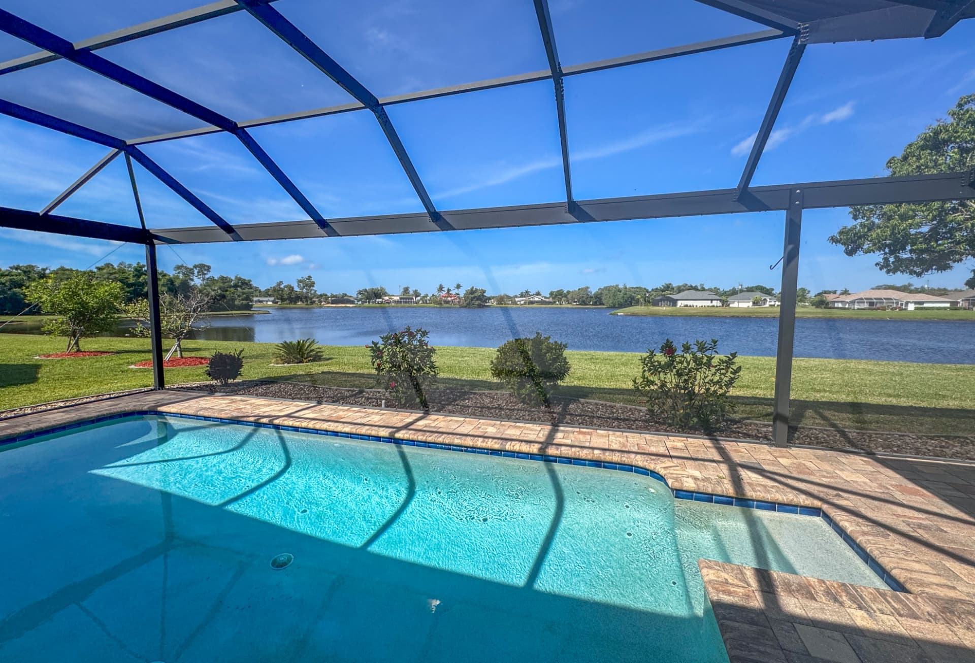Aluminum screen enclosure framing over a residential pool