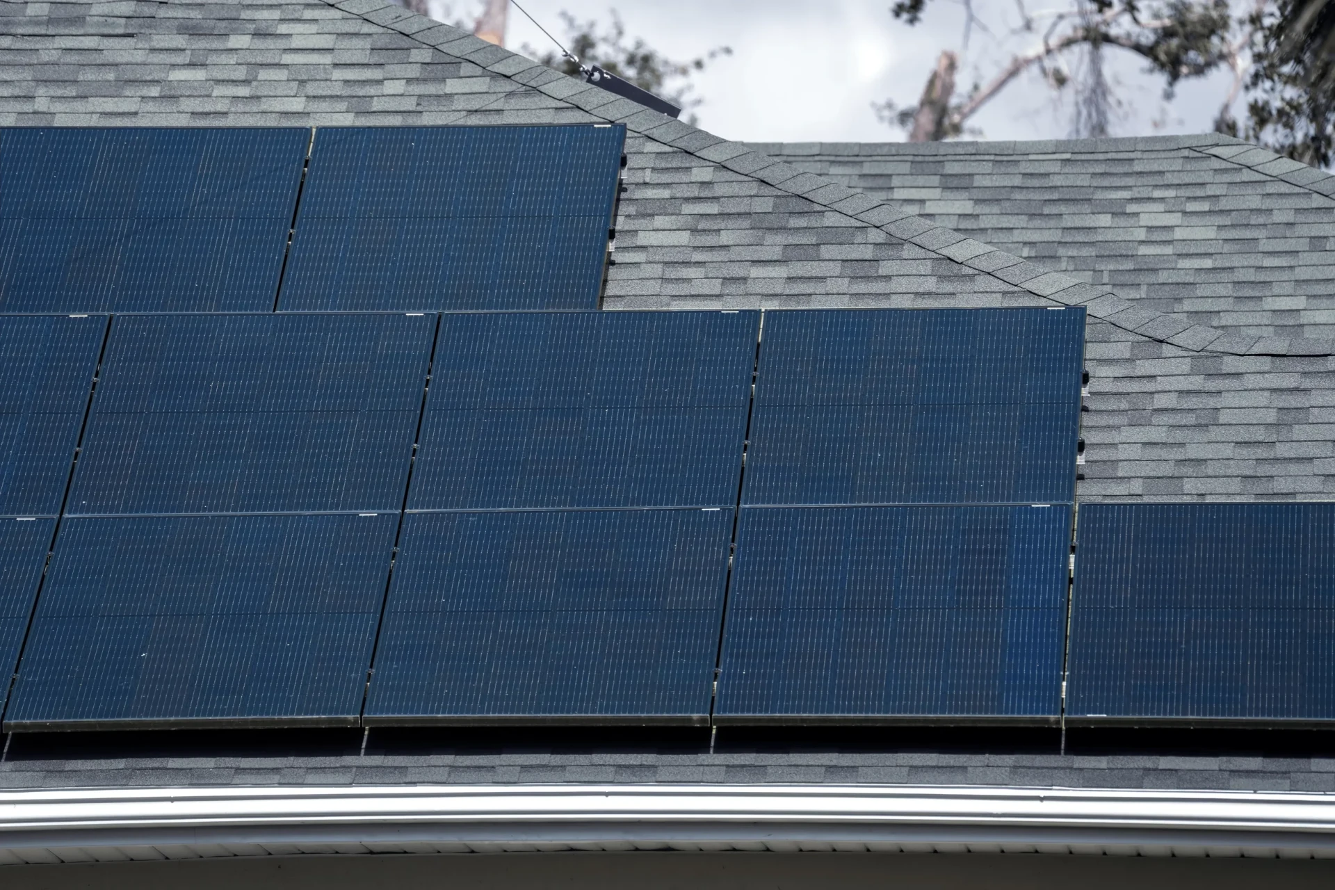 Technicians installing photovoltaic solar panels on a rooftop